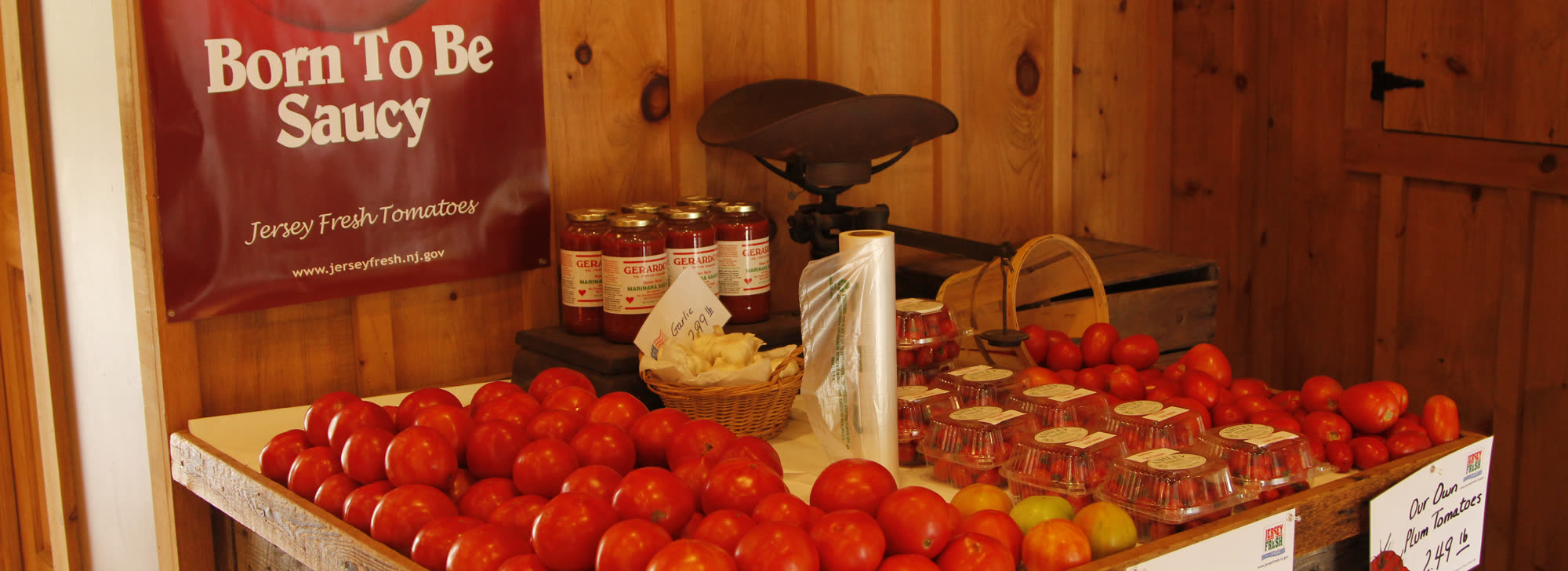 Jersey Fresh tomatoes and jars of sauce on the market counter